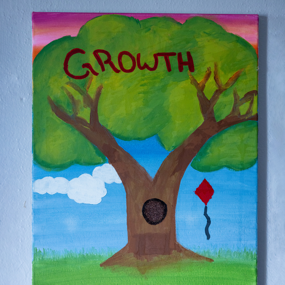 Painting of a tree that says growth